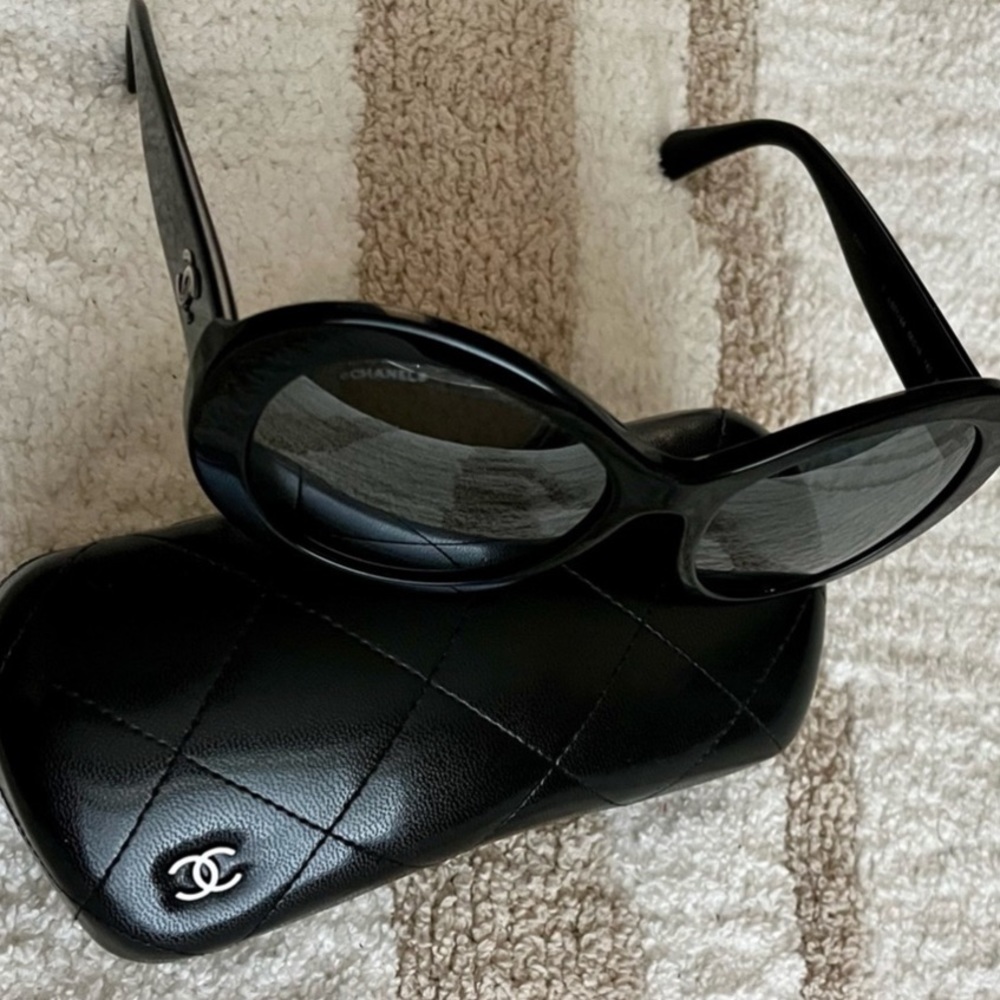 Chanel black oval frame sunglasses with hard case.